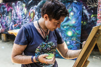 Photo of artist kelly boyle painting at ozora festival 2017